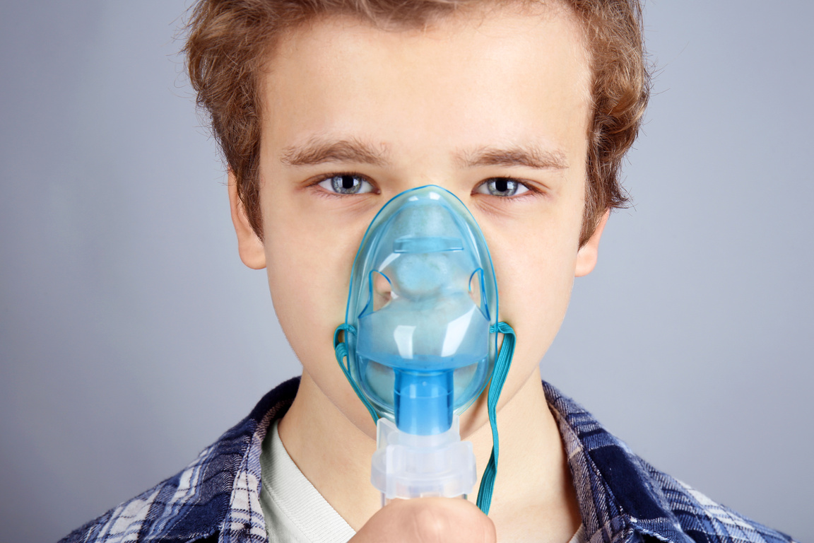 Young Boy Using Nebulizer for Asthma and Respiratory Diseases